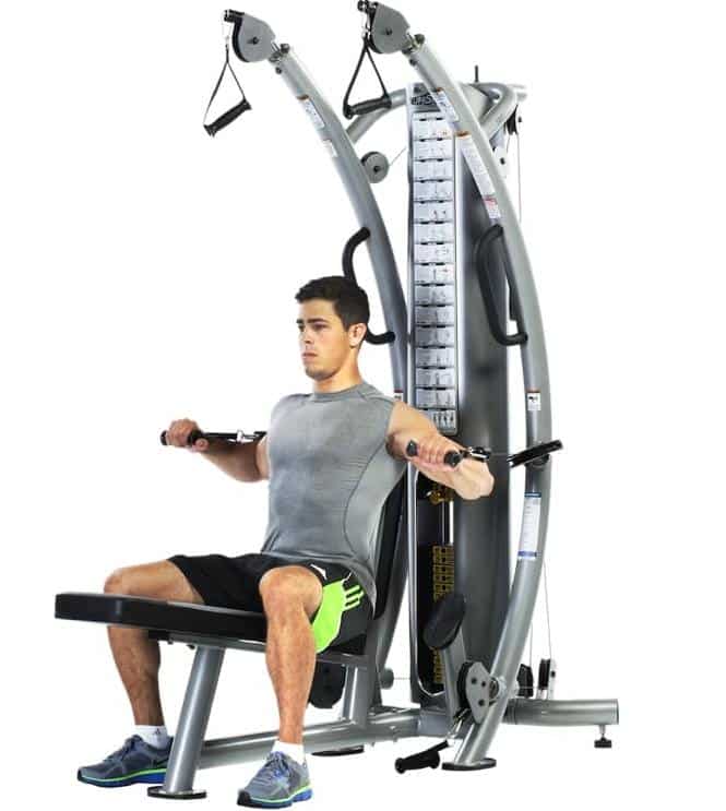 trainer doing chest press on the TuffStuff Six-Pak Functional Trainer (SPT-7)