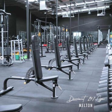 Row of adjustable tuff stuff benches in front of dumbbell racks